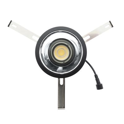 Runde LED-Leuchte mit zentraler Glühbirne, zwei Metallklammern und schwarzem Kabel. Ideal für moderne Beleuchtungslösungen und Energieeffizienz.