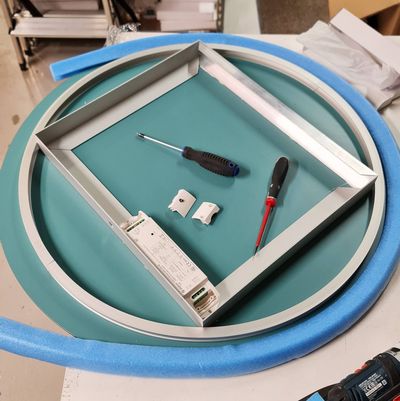 Zwei Schraubendreher und elektrische Komponenten mit blau-grüner Schaumstoffoberfläche, Akzentwerkzeuge für die Installation von LED-Beleuchtung.