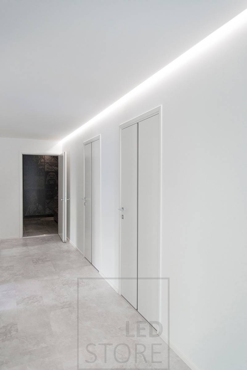Schöne Beleuchtung eines Korridors mit indirektem Licht, LED-Streifen in der Rille zwischen Decke und Wand installiert. Ledstore.fi