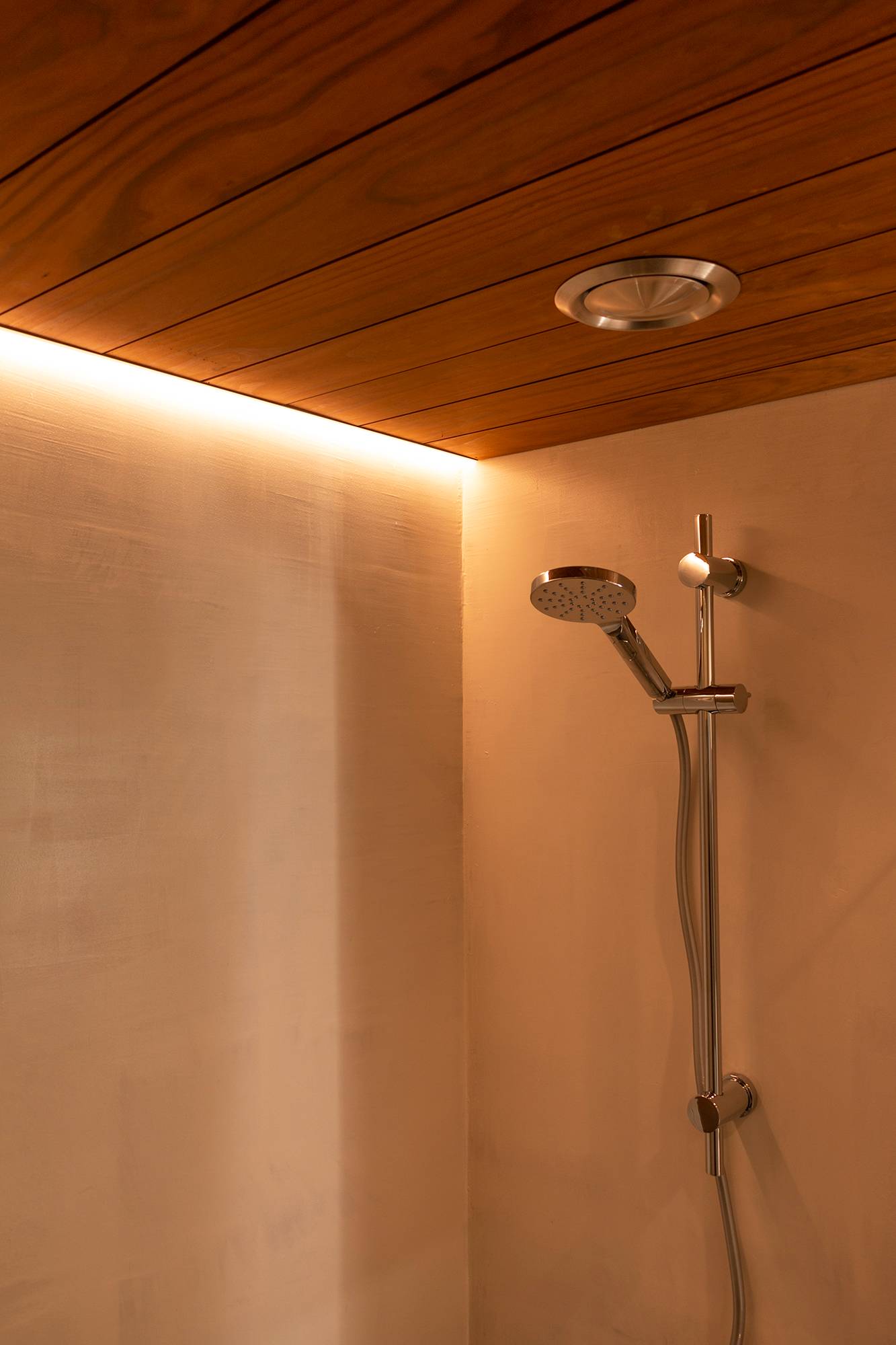 In einem Eckprofil, das bündig mit der Decke abschließt, beleuchtet ein LED-Band die Dusche. Ledstore.fi