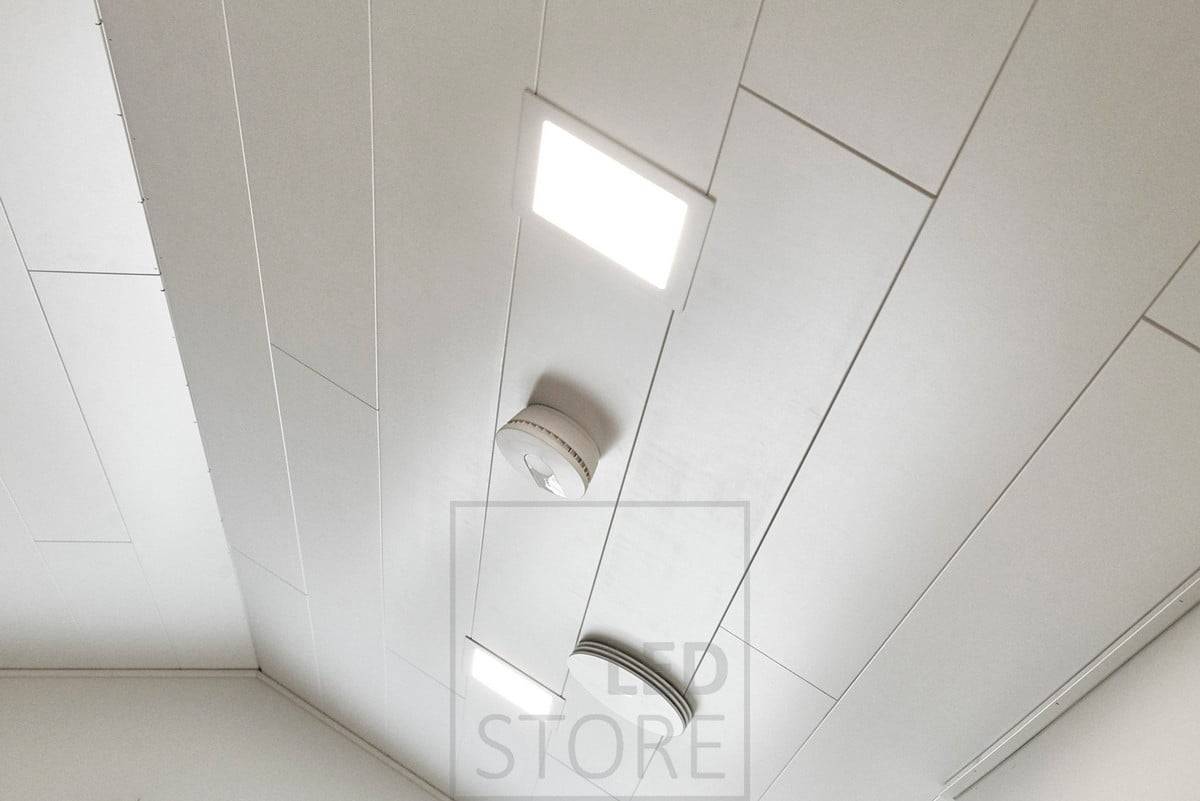 Paneelleuchte in einer schrägen Decke. Die Rahmen der Led-Paneelleuchten sind immer weiß lackiert, so dass sie sich elegant und anmutig in die Decke einfügen und einen sauberen Abschluss bilden. Ledstore.fi