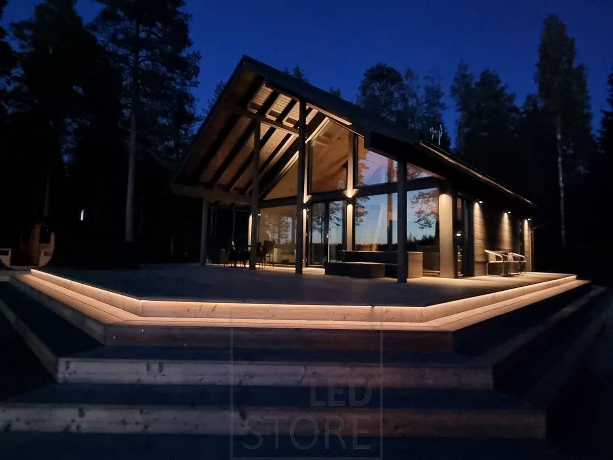 Vielseitige Außenbeleuchtung mit LED-Streifen an der Treppe und Wandleuchten. Die Wandleuchten leuchten in zwei Richtungen am oberen Punkt und in eine Richtung am unteren Punkt. Ledstore.fi