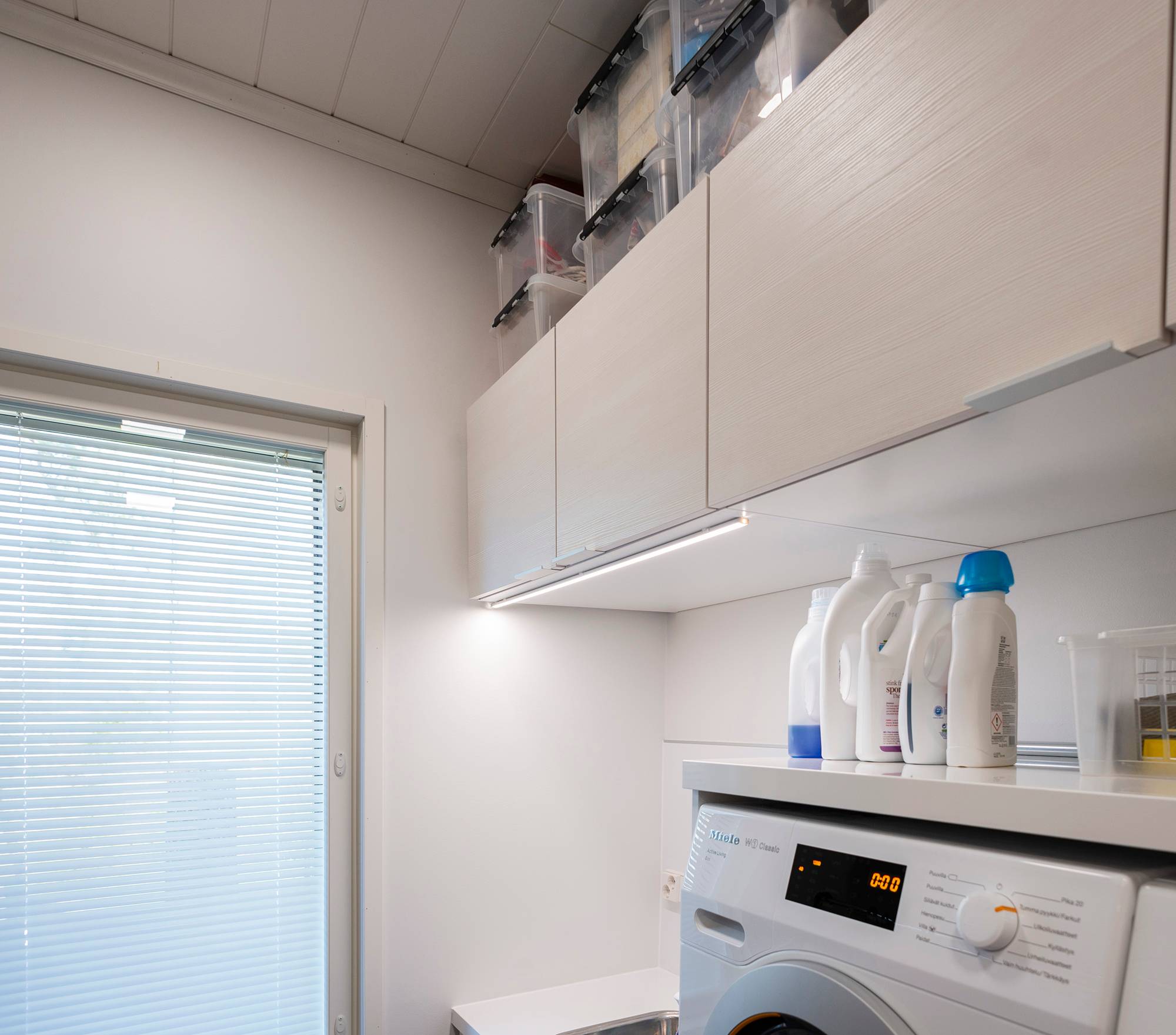 LED-Leiste für zusätzliches Licht im Hauswirtschaftsraum, angebracht an der Vorderkante des Schranks. Ledstore.fi