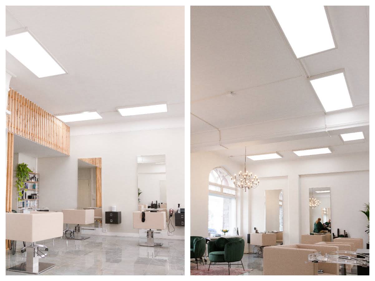 Heller Salon mit großen LED-Panels an der Decke.